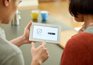 a man and woman holding a tablet computer