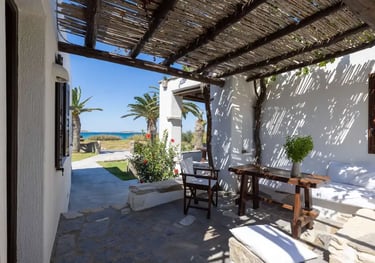 A pergola shaded veranda at one of the studios with a sea view
