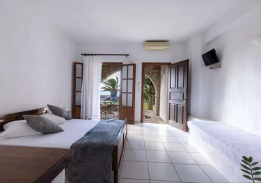 interior of a studio witha double bed and a sofa 