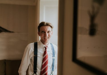 a man in a white shirt and suspender tie tie