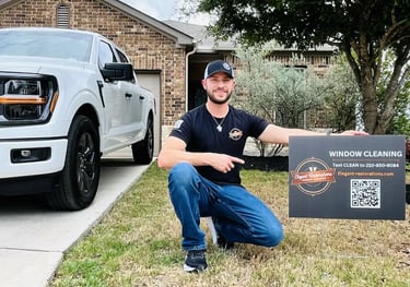 Alex Flores owner of Elegant Restorations Window Cleaning with yard sign in San Antonio TX
