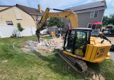 Photo of an excavator working in a yard