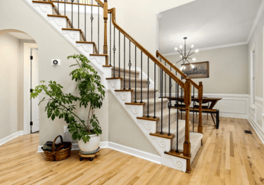 Staircase remodel with modern railing by Uprise Renovation in Charlotte home