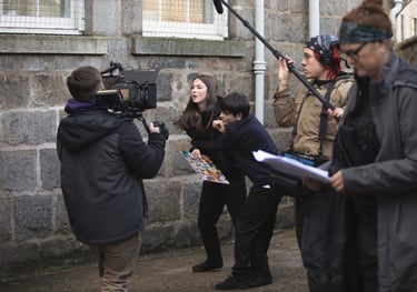 Commercials production companies: a woman filming with a camera and a second camera