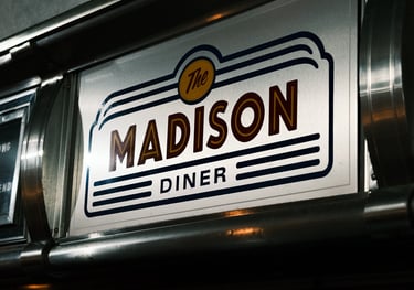 Sign displaying 'Madison Diner' captured by a commercial video production company