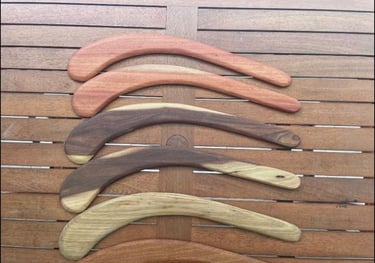 5 hunting boomerangs on a table made from recycled hardwood timber