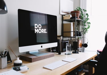 desk with monitor saying do more