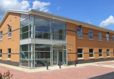 commercial building with beautiful glass entrance atrium, customer of C Thru Window Cleaning, Exeter.