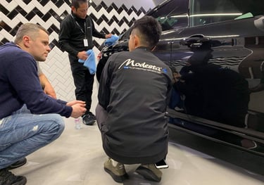 a man is sitting on the ground while another man is standing next to him