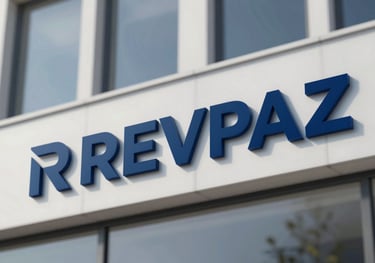 A modern building facade with the REVPAZ logo visible, representing the institution's official presence and reliability, featuring #0C2D48 corporate tones.