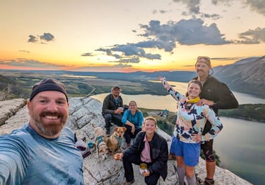 Friends and dogs at sunrise on Bear’s Hump above Upper Waterton Lake.