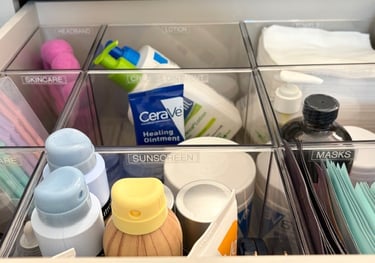 Bathroom drawer organization with acrylic inserts and labeled compartments for daily essentials