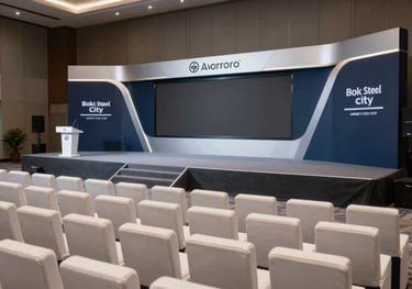 A professional corporate seminar setup in Bokaro Steel City, featuring modern seating, a high-tech stage, and sophisticated dark blue and silver branding elements.
