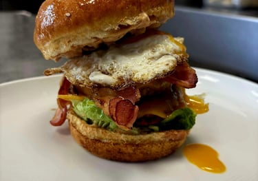 Gros plan gourmand sur un burger AD Burger avec fromage fondant et garniture fraîche au conceptstore