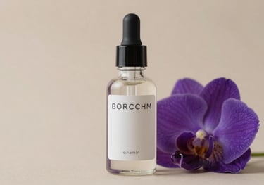 Close-up of a premium skincare glass bottle next to a fresh purple flower. The lighting is soft and the background is a neutral nude tone.