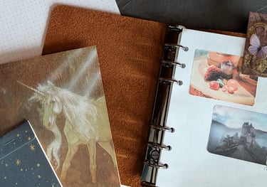 Flat lay of grid dot paper and photo stickers printed on labels in a pile of other journal-making materials.