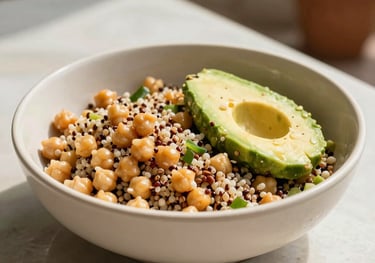 A vibrant grain salad with chickpeas, quinoa, and avocado, served in a light cream colored bowl, bright natural sunlight, South American outdoor patio setting, palette of sage and cream.