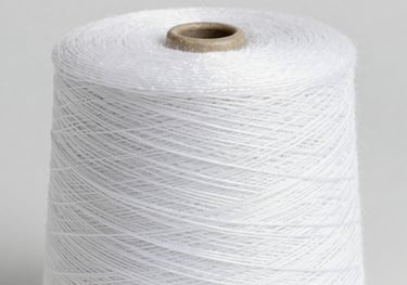 Close-up of a large spool of ultra-fine white micro-filament yarn, showing the intricate texture and high-quality finish, studio lighting on #F0F2F5 background.