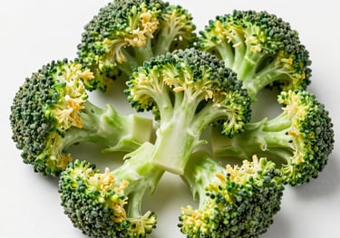 A top-down shot of freeze-dried broccoli florets on a white background. The florets look fresh and light, showcasing the premium freeze-drying process.
