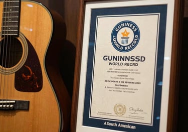 A close-up photograph of an official Guinness World Record certificate displayed elegantly next to a classic 1960s style guitar. The setting is a South American museum with premium finishings.