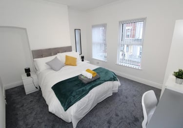 bedroom with bed and white walls
