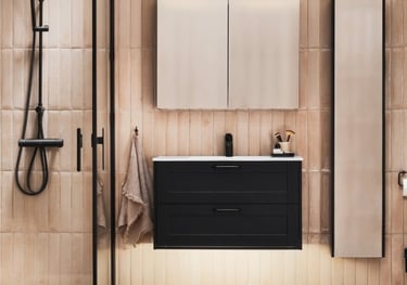Modern bathroom with black floating vanity, walk-in shower, and vertical beige tiles.