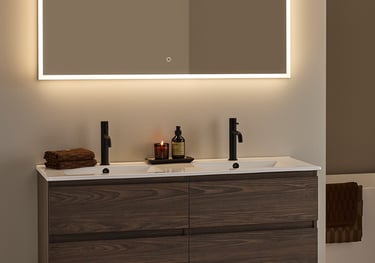 Modern floating double vanity with dark wood grain, matte black faucets, and a backlit LED bathroom mirror.