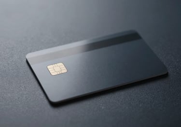 A clean, minimalist shot of a physical smart-card with a microchip resting on a polished dark navy surface, illuminated by soft accent lighting.