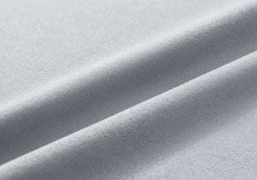 Close-up of high-performance sportswear fabric showing moisture-wicking texture in light gray #CBD5E0, studio lighting.