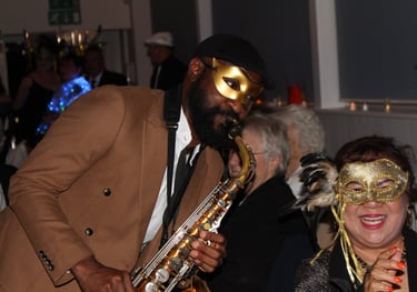Professional saxophonist performing at intimate London nightclub with warm ambient lighting