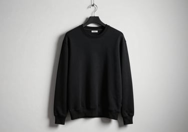 A high-end urban sweatshirt in deep black cotton displayed on a minimalist hanger against a white wall, fashion editorial style.