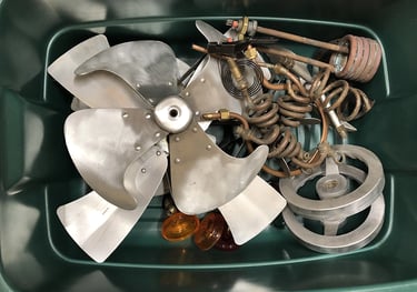 A sample of metal parts in a storage bin inside the Talbotics workshop.