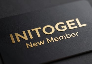 Close-up of a premium member card with gold embossed text, symbolizing the INITOGEL New Member privilege, set against a dark, textured background.