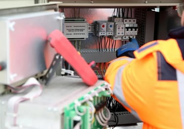 Electrician repairing electrical control panel