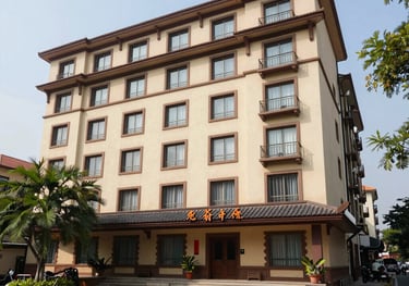 Night view of the hotel exterior illuminated against the dark sky.