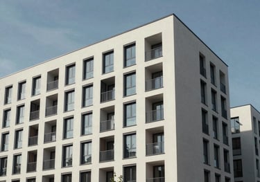 A professional architectural shot of a modern apartment building exterior in Magdeburg, showing high-quality construction under a clear sky.