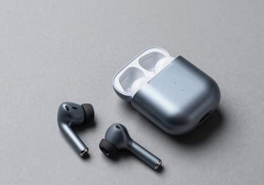 A high-end flat lay of premium wireless earphones and their compact charging case, clean minimalist layout on a neutral gray studio background, global context.