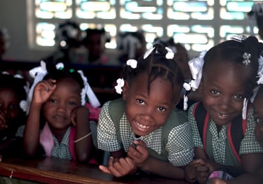 a group of children in school uniforms smiling and posing for a picture