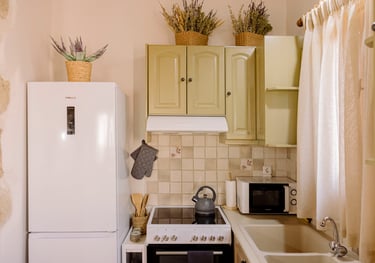 A kitchen with a refrigerator, microwave, and oven | Tonia's Cottage
