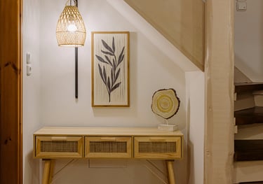 A rattan console table with a unique decoration and a beautiful lamp