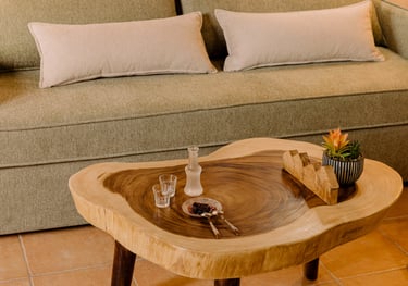 A couch with wooden table and Cretan raki