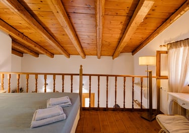 Tonia's Cottage maisonette bedroom with a wooden roof