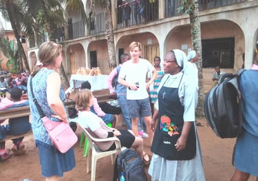 Missionary sisters speaking with community members during outreach event