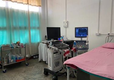 a hospital room with a bed and a computer monitor