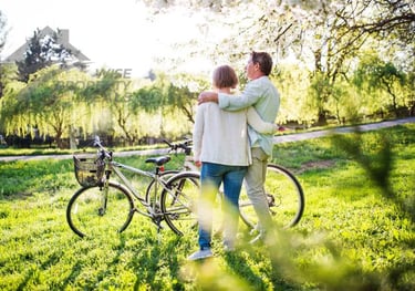 a man and woman standing in the grass