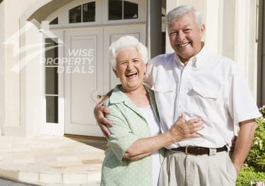a man and woman standing in front of a house