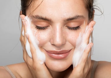 young woman cleansing skin