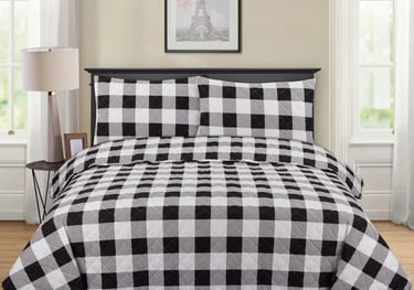 a bed with a black and white checkered checkered bedspread