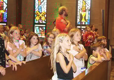 a group of children and adults in a church
