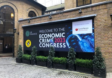 a photo of an outside banner with text reading welcome to the economic crime congress 2023